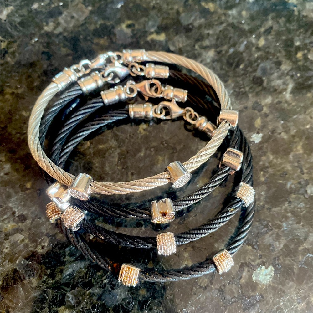 4 cable bracelets, 3 black one silver. Fits a small wrist.